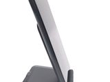 a cell phone sitting on a stand on a white surface