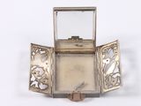 a small silver box with a mirror inside of it