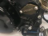 a close up of a motorcycle engine with a hose attached to it