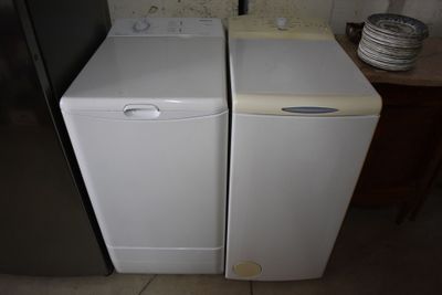 two washers and a dryer in the kitchen