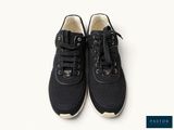 a pair of black sneakers with white soles on a white background