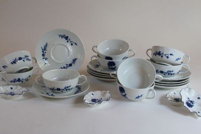 a lot of blue and white dishes and cups on the table