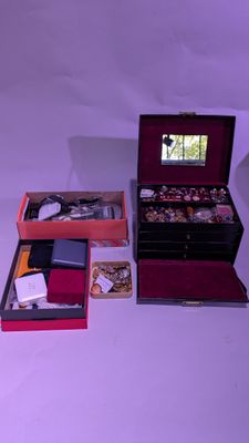 three boxes of jewelry sitting on a white surface