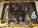 a small engine in the back of a yellow truck