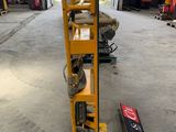 a yellow hand truck that is sitting in a warehouse