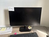 a computer monitor and keyboard sitting on a desk