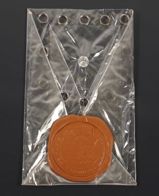 a wax seal in a plastic bag on a table
