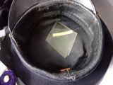 a black hat with a yellow tag in the middle of it