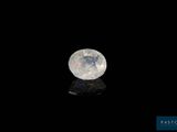 an image of a white moon in the dark sky with a reflection on the ground