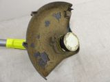 a metal object with a yellow handle on a white surface