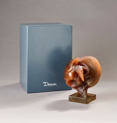 a sculpture of a snail on a stand next to a box