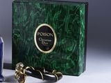 a bottle of perfume next to a box of perfumes