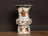 a white vase with a colorful design on it on a table