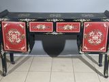 a red and black desk with two drawers on it