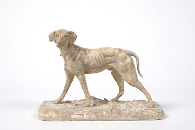 statue of a dog standing on a rock on a white background