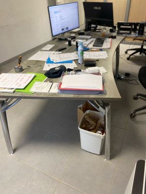 an image of a desk with a lot of papers on it