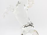 clear glass horse figurine on black surface with white background