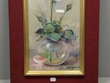 tableau représentant une rose rose dans un vase en verre posé sur une table