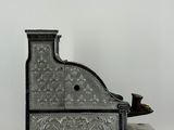 an antique silver plated desk with a bird perched on top of it