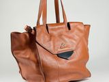 an image of a brown leather tote bag on a white background