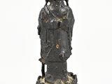 an old statue of a woman sitting on a rock on a white background