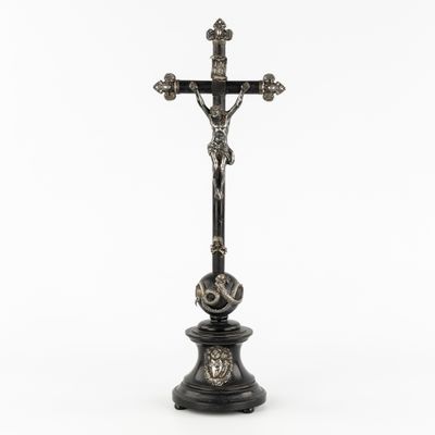 a cross on a pedestal on a white background