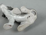 porcelain figurine of a giraffe laying down on its back