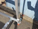 a metal gate with a handle on the side of a building