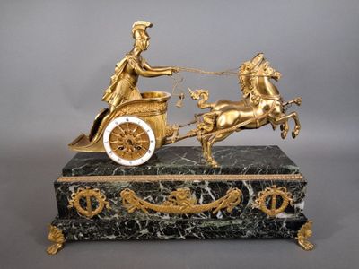 a statue of a man riding on a horse drawn carriage