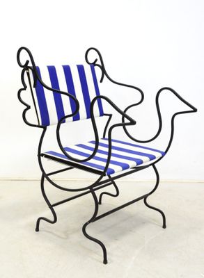 a blue and white striped chair sitting on a white floor
