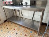 a stainless steel work table with a microwave on top of it
