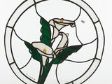 a stained glass picture of a white flower in a circle
