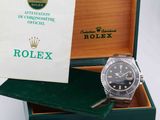 rolex watch in a box with a keychain and other items