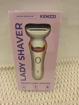 the box is open on the table with a razor in it