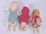 three little dolls that are standing next to each other