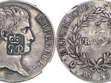 a close up of a coin on a white surface