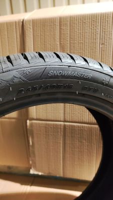 a close up of a tire on a box with boxes in the background