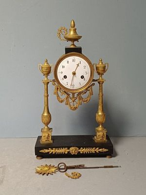 a clock that is sitting on a table next to a pair of scissors