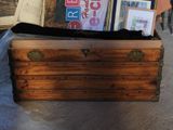 a trunk that has a bunch of books on top of it