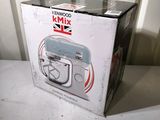 boxed box of kenwood kmix mixer on a white table