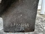 statue of a man sitting on top of a cement slab