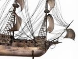 an old wooden model of a sailing ship on a wooden base