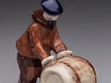a figurine of a man with a barrel of beer