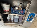 an image of a stainless steel cabinet filled with bottles and containers