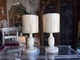 two candles that are sitting on a clear table