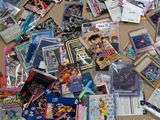 a pile of various anime cards on the floor