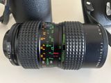 a camera with a lens attached to it next to a camera bag
