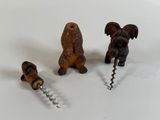 a bottle opener with a dog on it and a bottle opener with a dog on it