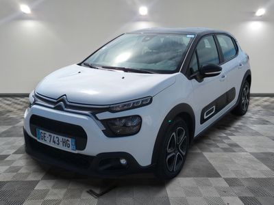 a white citrole parked in a room with a checkered floor