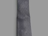 the tie is gray and has a black stripe on it